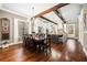 Elegant dining room featuring hardwood floors, wooden beams and view into kitchen at 1545 Camden Cove Dr, Cumming, GA 30040