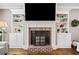 Close-up of fireplace with custom built-ins, brick surround, and decorative mantel at 1545 Camden Cove Dr, Cumming, GA 30040