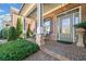 Charming front porch featuring brick pavers, stone pillars, and a decorative front door at 1545 Camden Cove Dr, Cumming, GA 30040