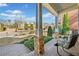 Inviting covered porch with stone columns and comfortable seating area overlooking the front yard at 1545 Camden Cove Dr, Cumming, GA 30040