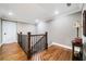 Upstairs hallway featuring hardwood floors, neutral paint and stylish fixtures at 1545 Camden Cove Dr, Cumming, GA 30040