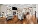 Spacious living room featuring a fireplace, built-in shelving, and hardwood floors at 1545 Camden Cove Dr, Cumming, GA 30040