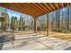 Covered patio with wood ceiling and forest views perfect for entertaining at 1545 Camden Cove Dr, Cumming, GA 30040
