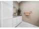 Powder room featuring a granite countertop, white cabinetry, and a decorative mirror at 1545 Camden Cove Dr, Cumming, GA 30040