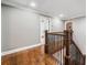 Upstairs hallway with hardwood floors, iron railing, and access to the bathroom at 1545 Camden Cove Dr, Cumming, GA 30040
