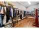 Spacious walk-in closet featuring ample clothing racks, shelving, and hardwood floors at 1545 Camden Cove Dr, Cumming, GA 30040