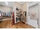 Elegant walk-in closet with a built-in shoe rack, full-length mirror, and bathroom access at 1545 Camden Cove Dr, Cumming, GA 30040