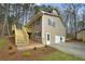 Side view of a tan home featuring a new deck, driveway, and two-car garage at 1630 Acworth Due West Nw Rd, Kennesaw, GA 30152