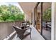 Covered balcony offers outdoor seating and views of the lush surrounding greenery at 2575 Peachtree Ne Rd # 6G, Atlanta, GA 30305