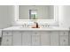 Bright bathroom with dual sinks, a marble countertop, and modern fixtures at 2575 Peachtree Ne Rd # 6G, Atlanta, GA 30305