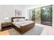 Serene bedroom with a platform bed, neutral tones, and large glass doors to a balcony at 2575 Peachtree Ne Rd # 6G, Atlanta, GA 30305