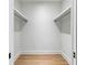 Empty walk-in closet with wooden floors and shelving provides generous storage space at 2575 Peachtree Ne Rd # 6G, Atlanta, GA 30305