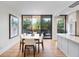 Dining area with modern table setting offers outdoor views and access to sleek kitchen area at 2575 Peachtree Ne Rd # 6G, Atlanta, GA 30305