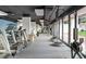Well-equipped gym featuring treadmills, stationary bikes, a trampoline, and large windows with a view of the outdoors at 2575 Peachtree Ne Rd # 6G, Atlanta, GA 30305