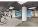 Spacious gym with modern equipment, sleek lighting, mirrored walls, and a blue accent wall for a fresh, energetic vibe at 2575 Peachtree Ne Rd # 6G, Atlanta, GA 30305