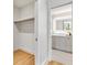 Hallway view showcases a walk-in closet and a well-lit bathroom beyond an open doorway at 2575 Peachtree Ne Rd # 6G, Atlanta, GA 30305