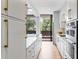 Stylish modern kitchen offers a long center island, stainless appliances, and sleek white cabinets at 2575 Peachtree Ne Rd # 6G, Atlanta, GA 30305
