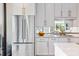 A modern kitchen featuring stainless steel refrigerator, white cabinets, and marble countertop at 2575 Peachtree Ne Rd # 6G, Atlanta, GA 30305