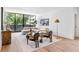 Bright living room with stylish seating, floor-to-ceiling windows, and a modern aesthetic at 2575 Peachtree Ne Rd # 6G, Atlanta, GA 30305