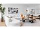 Bright living room features a modern curved couch, stylish decor, and hardwood floors at 2575 Peachtree Ne Rd # 6G, Atlanta, GA 30305
