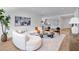 Bright living room features a modern curved couch, stylish decor, and hardwood floors at 2575 Peachtree Ne Rd # 6G, Atlanta, GA 30305