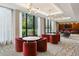 Elegant lounge area with plush seating, round tables, large windows with natural light, and stylish light fixtures at 2575 Peachtree Ne Rd # 6G, Atlanta, GA 30305