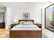 Comfortable main bedroom features a modern bed, neutral decor and natural light at 2575 Peachtree Ne Rd # 6G, Atlanta, GA 30305
