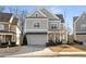 Two-story home with gray siding, a front porch, and a two-car garage at 3018 Eamont Ter, Atlanta, GA 30328