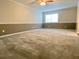 Spacious living room with neutral carpeting and two-tone walls at 927 Pine Oak Trl, Austell, GA 30168