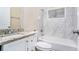 Modern bathroom featuring white marble tiles, a vanity with a granite countertop, and a bathtub at 2318 Ousley Ct, Decatur, GA 30032