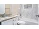 Bathroom featuring marble tile, a granite countertop, and shower and tub at 2318 Ousley Ct, Decatur, GA 30032
