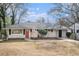 Charming single story home with a red front door and well-maintained landscaping at 2318 Ousley Ct, Decatur, GA 30032