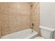 Cozy bathroom with a white tub and shower with beige-tiled surround and matching fixtures at 2479 Peachtree Ne Rd # 1012, Atlanta, GA 30305