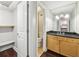 Bathroom featuring wood cabinets, a granite countertop, and an adjacent walk-in closet at 2479 Peachtree Ne Rd # 1012, Atlanta, GA 30305
