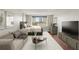 Well-lit bedroom with a neutral color palette, comfortable seating, and a large TV at 2479 Peachtree Ne Rd # 1012, Atlanta, GA 30305
