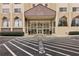 Striking building entrance with covered drop-off, detailed facade, and manicured landscaping offers convenience and curb appeal at 2479 Peachtree Ne Rd # 1012, Atlanta, GA 30305