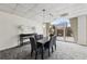 Comfortable common area with dining table and chairs has sliding glass doors to an outdoor area at 2479 Peachtree Ne Rd # 1012, Atlanta, GA 30305