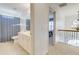 Bright bathroom with a shower, toilet, sink, and view of the second floor landing at 3120 Esplanade Sw Cir, Atlanta, GA 30311