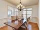 This is a dining room area with a dark wood table and ornate chandelier at 3120 Esplanade Sw Cir, Atlanta, GA 30311