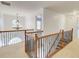 Bright upstairs hallway with carpet flooring, chandelier, and decorative wrought iron staircase at 3120 Esplanade Sw Cir, Atlanta, GA 30311