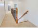 Hallway with carpet flooring and a wooden staircase with decorative wrought iron spindles at 3120 Esplanade Sw Cir, Atlanta, GA 30311