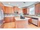 Bright kitchen with wood cabinets, island, granite countertops and stainless appliances at 3120 Esplanade Sw Cir, Atlanta, GA 30311