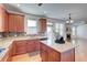 Open kitchen featuring wood cabinets, granite countertops, mosaic backsplash, and center island at 3120 Esplanade Sw Cir, Atlanta, GA 30311