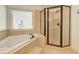Bright main bathroom features a large soaking tub, shower and tile flooring at 3120 Esplanade Sw Cir, Atlanta, GA 30311