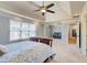 Large main bedroom with tray ceilings, ceiling fan, and large windows at 3120 Esplanade Sw Cir, Atlanta, GA 30311