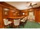 Basement bar with off-white barstools and wood features at 3450 Ridgewood Nw Rd, Atlanta, GA 30327