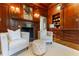 Cozy library with wood paneling, built-in shelves, and a fireplace at 3450 Ridgewood Nw Rd, Atlanta, GA 30327