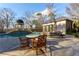 Relaxing pool area with table and chairs near the pool house at 3450 Ridgewood Nw Rd, Atlanta, GA 30327