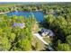 Overhead view of a beautiful lakeside home surrounded by mature trees and manicured lawn at 45 Kinloch Ct, Covington, GA 30014