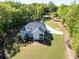 Aerial view of the back of the house showing a back deck, screened in porch and mature landscaping at 45 Kinloch Ct, Covington, GA 30014